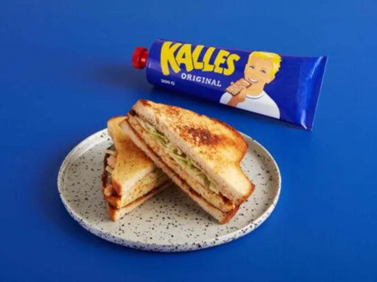 Kalles Kaviar Original, Swedish Kalles Kaviar Creamed Smoked Cod Roe Spread served on a plate with toasted sandwiches.