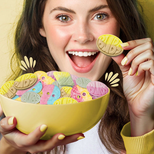 Young woman excitedly holding Bubs Swedish candy mix in a bowl, showcasing vegan gelatin-free Swedish candy.